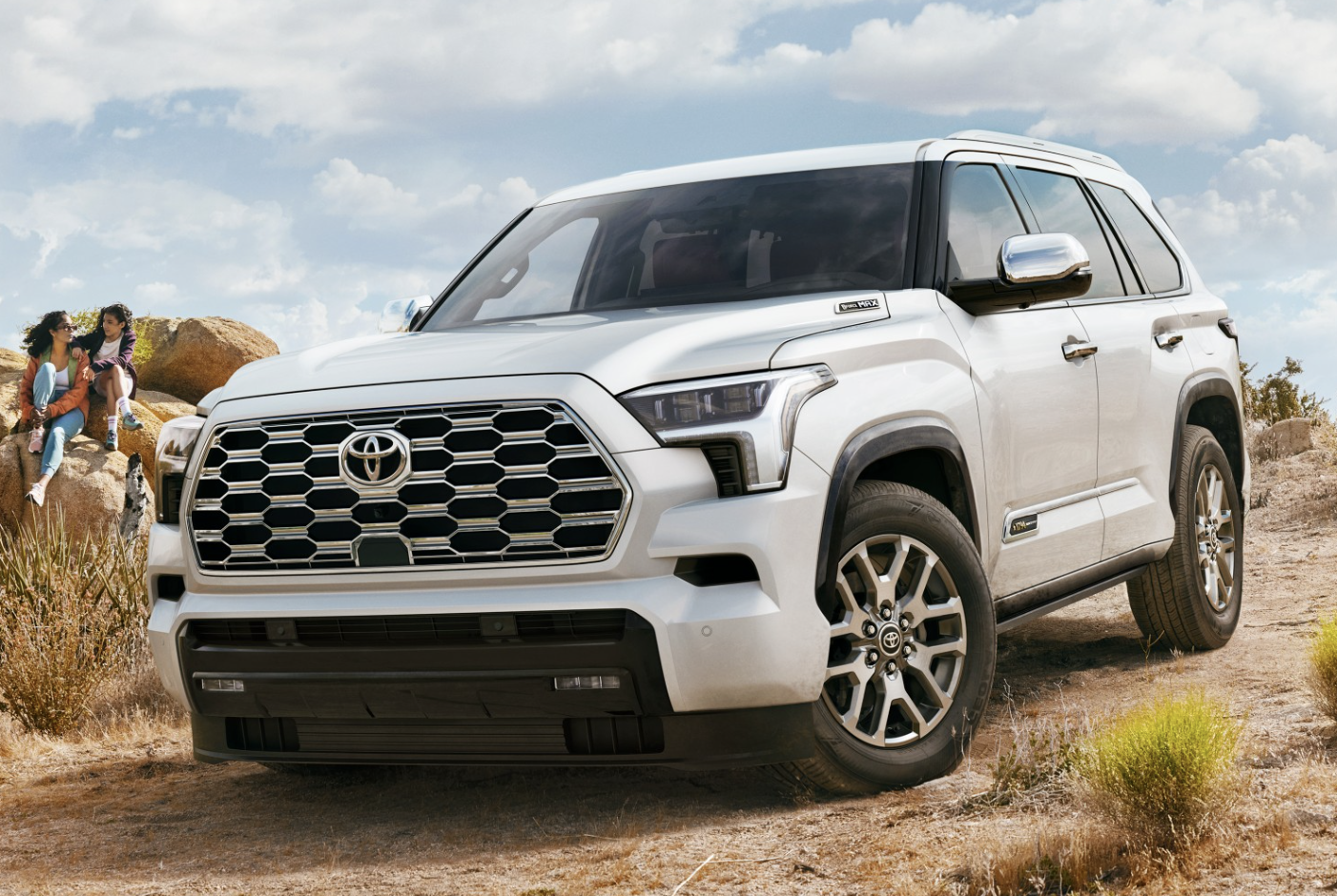 Family standing next to toyota